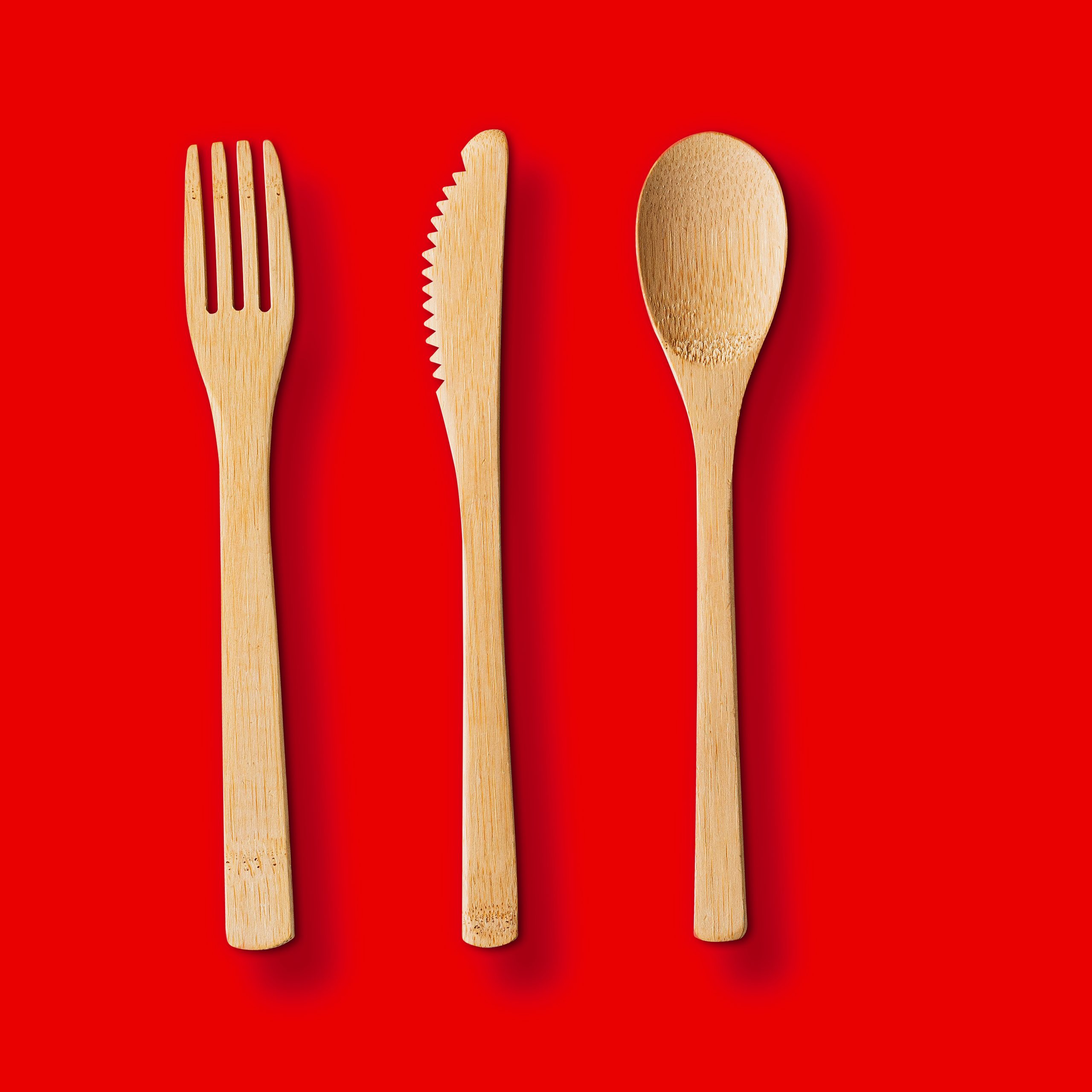 Wood utensils over red background