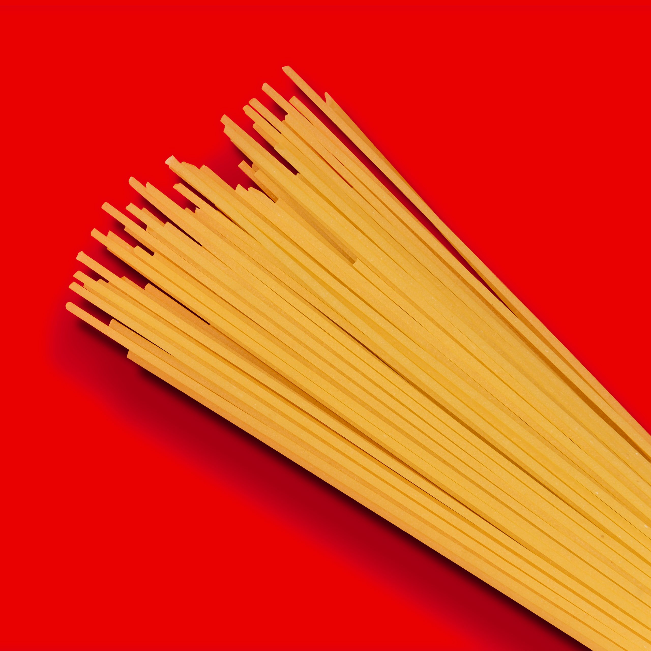 Dry pasta over red background